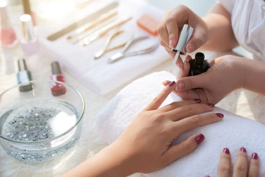 A person getting their nails done at the nail salon